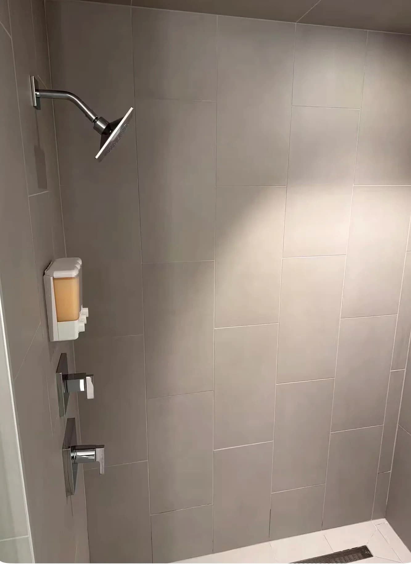 Walk-in tiled shower with a rainfall showerhead in a furnished Santa Monica rental